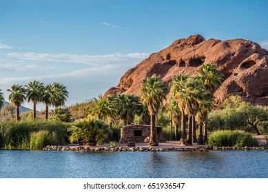 Phoenix, Arizona, USA - The Hole-in-the-Rock natural geological formation is visible from across one of Papago Park's ponds.