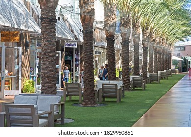 Phoenix, Arizona/USA - October 8 2020: Shoppers Stroll Beneath Palm Trees And Cooling Misters At The Desert Ridge Marketplace Shopping Center.  