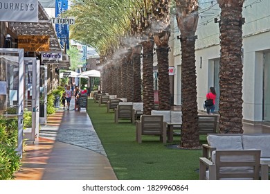 Phoenix, Arizona/USA - October 8 2020: Shoppers Stroll Beneath Palm Trees And Cooling Misters At The Desert Ridge Marketplace Shopping Center.  