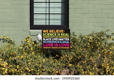 Phoenix, AZ - Mar. 20, 2021 We Believe Sign In A Front Yard Says Science Is Real, Womens Rights Are Human Rights, Black Lives Matter, No Person Is Illegal, Love Is Love And Diversity Makes Us Stronger