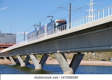 Phoenix, AZ - March 7, 2020: Valley Metro Light Rail Running Over The Salt River. The 26- Mile Valley Metro Light Rail Runs From Upper Central Phoenix To Downtown Mesa And Sky Harbor Airport.