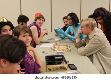Phoenix, AZ - May 27, 2017 A group of friends play tabletop games at Phoenix Comic Con 2017.