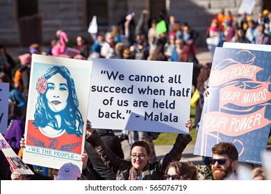Phoenix, AZ, USA - January 21, 2017: A group of protesters carry signs at the state capitol at the women's march in Phoenix, AZ,  one of hundreds of sister demonstrations in cities around the world.