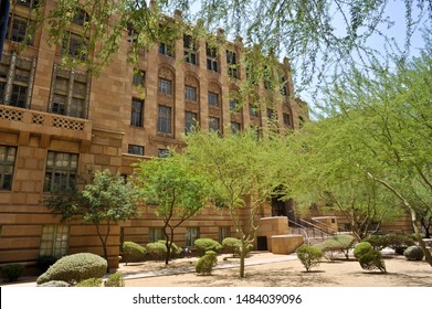 PHOENIX, AZ / USA - July 6 2011: Maricopa County Courthouse Building Downtown Phoenix, Behind Palo Verde Trees With Green Bark.