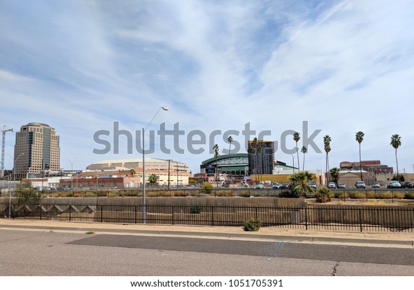 PHOENIX, AZ, USA - MARCH 16, 2018: Bank of America\
financial center tower, Talking Stick Resort Arena, Diamond Backs\
stadium and other commercial buildings as seen from 1st Avenue and\
Jackson Stree
