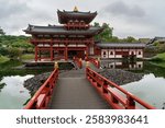 Phoenix Hall of the Buddhist temple Byodo-in on the shore of the Aji-ike Pond on a cloudy autumn day, Uji, Kyoto Prefecture, Japan