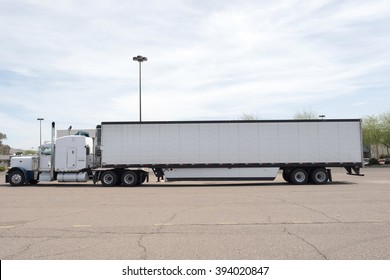 Phoenix, USA - March 15, 2016: white trailer side view of a huge white Peterbilt truck parked on a parking in Phoenix, Arizona. Peterbilt manufactures medium and heavy-duty trucks since 1939.