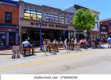Phoenixville, PA, USA - June 14, 2020: Social distancing and dining on the main thoroughfare is on display as a street closure is effective for pedestrians.