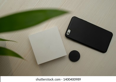 Phone Accesories Background With Multiple Accesories Like A New Box, Popsocket And Case.