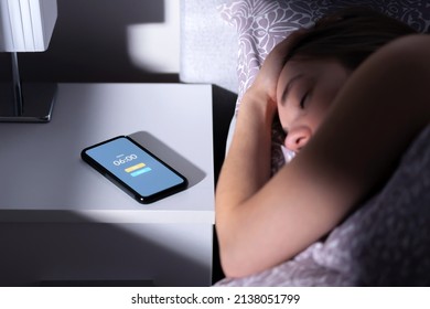 Phone Alarm Waking Up Tired Sleeping Woman In Bed At Night Or Morning. Cellphone On Table With Clock Timer And Snooze Button. Oversleeping Person, Late From Work. Sleepy, Lazy Or Overslept Lady.