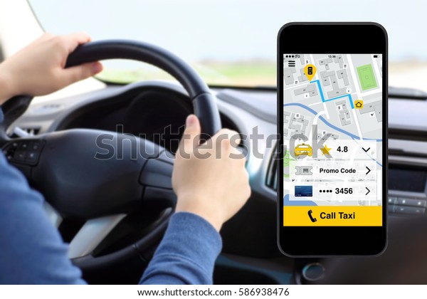 phone with application call taxi on screen background\
man driving car