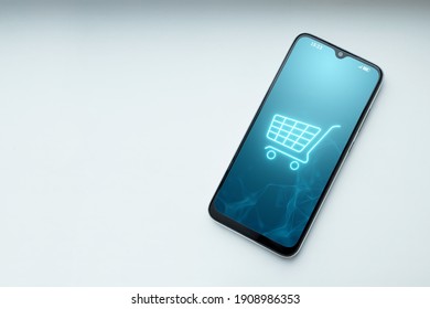 Phone and basket hologram. Online shopping, online store application in a smartphone. Digital Marketing Online