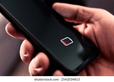 Phone battery with low charge. Cellphone with no power. Energy drain. Empty load and dead smartphone. Mobile recharge life icon symbol on screen. Man holding device in hand. Bad broken technology.