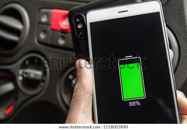 Phone battery\
wireless charge sharing technology. Wireless charge sharing\
smartphone in the car in rainy\
weather
