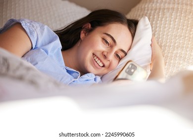 Phone, bed and relax woman typing post to social media app, online blog or doing internet web search. Bedroom, networking communication or gen z girl reading meme, news or contact social network user
