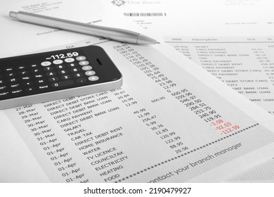 Phone Calculator And Bank Statement Showing Account In Debt