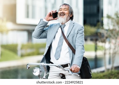 Phone Call, Businessman And Cycling Asian Man On A Trip Or Journey To Work In The City During The Day. Cycle, Bike And Bicycle With Male Businessperson On Cellphone Communication During Urban Commute