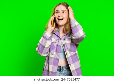 Phone call, good news, gossip. Happy surprised young caucasian woman involved in pleasant conversation on smartphone, enjoying talking with friend. Redhead girl isolated on green chroma key background - Powered by Shutterstock