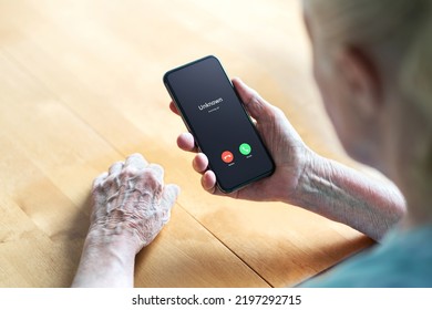 Phone call to old woman from scam or fraud caller. Elder senior answering to unknown number. Smartphone scammer or mobile hoax, catfish or phishing concept. Stalker or stranger. Grandma with cellphone