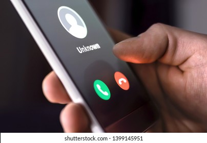 Phone call from unknown number late at night. Scam, fraud or phishing with smartphone concept. Prank caller, scammer or stranger. Man answering to incoming call. Hoax person with fake identity. - Shutterstock ID 1399145951