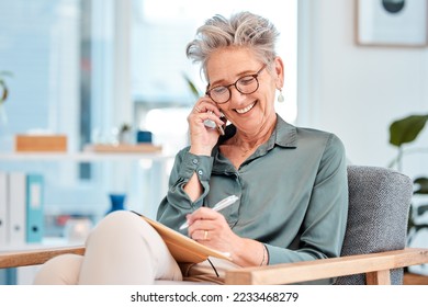 Phone call, writing and schedule with a female leader, manager or CEO talking while making an appointment in her notebook. Mobile, communication and diary with a senior business woman writing notes - Powered by Shutterstock