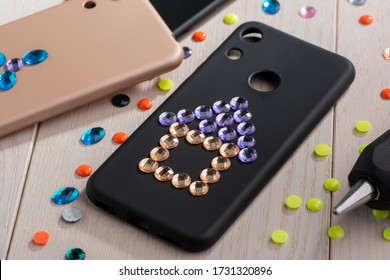 Phone Cases Decorated With Rhinestones. House And Flower Art. Cute Child's DIY Project.