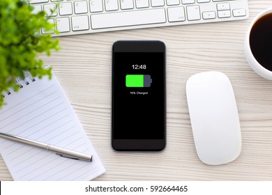 phone with charged battery screen on table in office