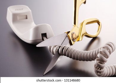 Phone Cord Being Cut By Scissors