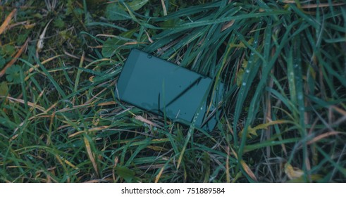 phone in the grass,rain on screen 