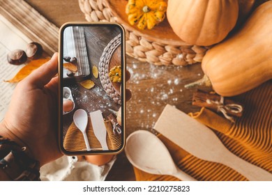 Phone in hands with a photo of the ingredients for the pie, cooking.