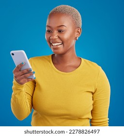 Phone, happy and black woman typing in studio for social media, text message and browse website. Communication mockup, technology and girl on internet, networking and chat online on blue background - Shutterstock ID 2278826497