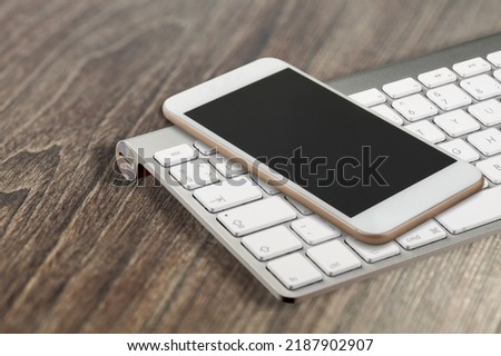 Phone with keyboard on table, request to access code enter to device interface