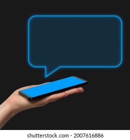 Phone message, chat. A woman's hand holding the phone in her hand on a dark background, the chat window is added as a graphic element. - Shutterstock ID 2007616886