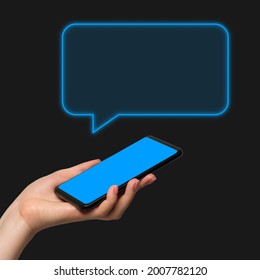 Phone message, chat. A woman's hand holding the phone in her hand on a dark background, the chat window is added as a graphic element. - Shutterstock ID 2007782120