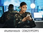 Phone, military and woman soldier in the control room in uniform for war or battle networking. Happy, smile and young female army warrior typing a message on internet with cellphone for surveillance.