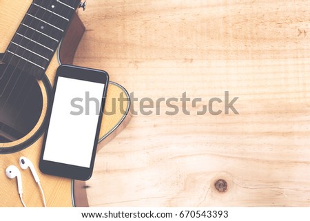 phone mobile showing screen on guitar top view music concept