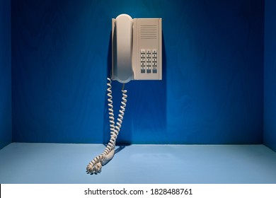 Phone mounted on the wall of a blue booth