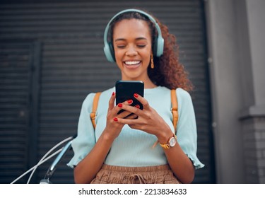 Phone, music and social media with a black woman streaming audio through a subscription service in the city. Travel, communication and text message with a young female networking in an urban town - Powered by Shutterstock