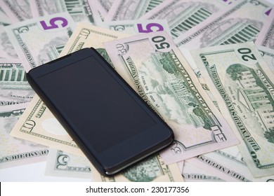 Phone On A Background Of Money. Concept.