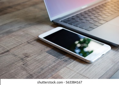 Phone on table. phone mobile with laptop computer. - Shutterstock ID 563384167