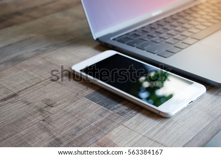 Phone on table. phone mobile with laptop computer.