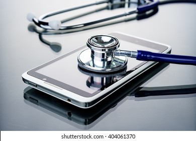 Phone repair and service concept.Smartphone being diagnosed with a stethoscope. - Shutterstock ID 404061370