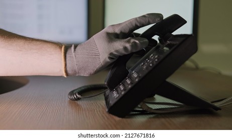 Phone Scam And Night Theft By Criminal Hacker On Telephone Call. Man Hand In A Black Glove With A Phone On A Dark Background