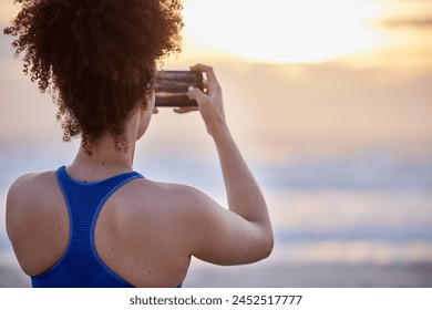 Phone screen, photography and woman with beach sunset for travel, memory or running fitness break. Sunrise, back and runner smartphone for social media, blog and profile picture at sea for training - Powered by Shutterstock