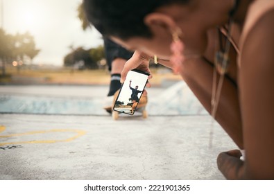 Phone, skate and photograph with a woman recording a man skater at the skatepark for fun or recreation. Mobile, skating and picture with a male athlete riding a board while a friend is filming - Powered by Shutterstock