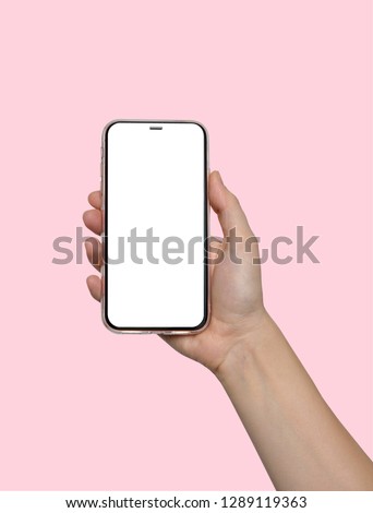 Phone. Smart. Hand woman holding the pink smartphone with blank screen on white background. Modern frameless design. Clever.