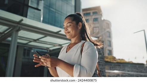 Phone, smile and wind with businesswoman in city, walking on street or sidewalk for morning work commute. Contact, mobile or social media with happy young employee in urban town for travel journey - Powered by Shutterstock