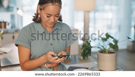 Phone, social media and communication with a business asian woman typing a text message at work. Contact, mobile and search with a female employee sending a reply while texting in the office