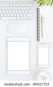 Phone And Tablet Blank Screen On White Table Format Vertical Top View