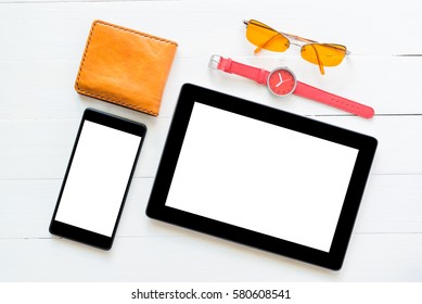 phone and tablet computer on white wood table